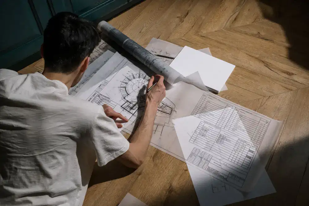 Designer sketching a planting layout on site