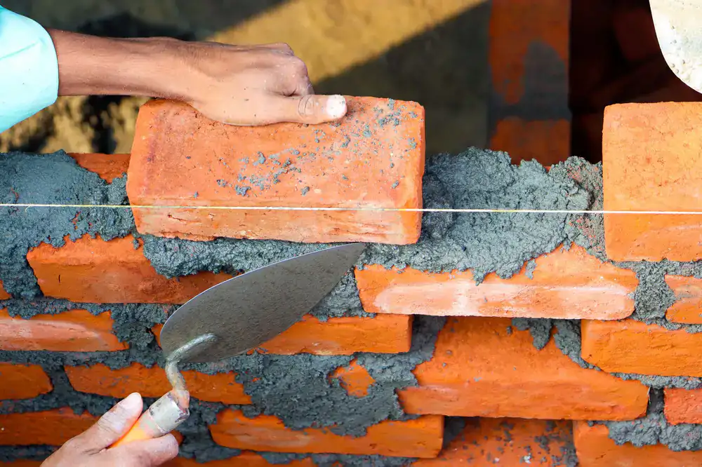 Stone mason working on a garden terrace wall