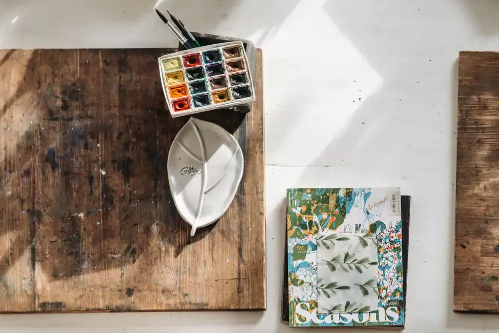 Design tools and botanical prints on a studio desk